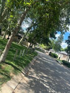 a street with trees on the side of a road at Riverside 1 bedroom house for Two in Nelspruit