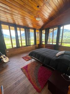 a bedroom with a bed in a room with windows at Nodriza House in Baeza