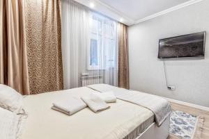 Postel nebo postele na pokoji v ubytování 1-но комнатные апартаменты в ЖК Promenade Expo