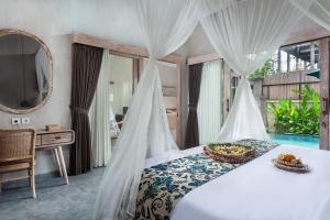 Postel nebo postele na pokoji v ubytování Uma Githa Ubud by Pramana Villas