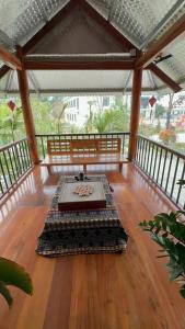 a room with a table on a wooden floor at Happy House Homestay in Yên Bái +71 photos