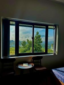 a room with a window with a table in front of it at Home Anh Thy in Ấp Tân Hà