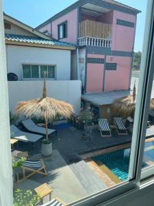 a view of a patio with chairs and an umbrella at Lanta Corsica Hotel in Ko Lanta