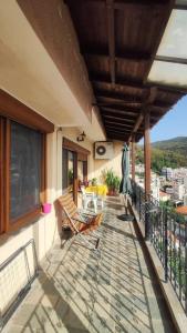 a balcony of a house with two chairs on it at Poly's House in Kavála +7 photos