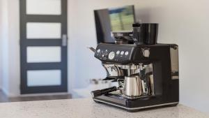 a black coffee maker sitting on a counter at 52a Chalmers Street Flynns Beach in Port Macquarie