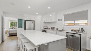 a kitchen with white cabinets and a counter top at 52a Chalmers Street Flynns Beach in Port Macquarie +8 photos