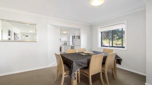 a dining room with a table and chairs at 213 South Pacific Apartments in Port Macquarie