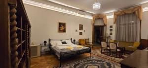 a bedroom with a bed and a living room at Moods Apartmans in Szeged