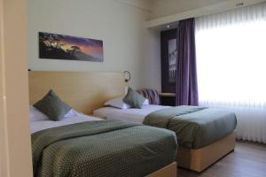 Postel nebo postele na pokoji v ubytování Lux Tychi Hotel