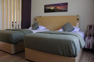 Postel nebo postele na pokoji v ubytování Lux Tychi Hotel