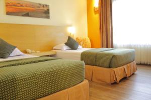 Postel nebo postele na pokoji v ubytování Lux Tychi Hotel