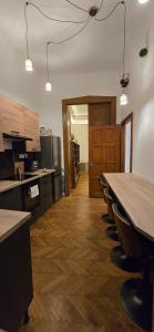 an empty kitchen with a long table and chairs at Moods Apartmans in Szeged