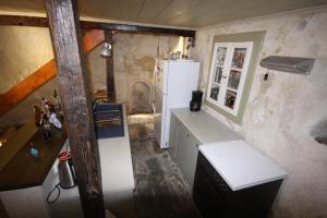 a small kitchen with a refrigerator in a room at Apollonos Seafront Apartment in Ermoupoli