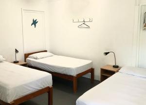 a room with two beds and two lamps in it at Great Keppel Island Holiday Village in Great Keppel +38 photos