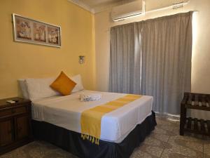 a bedroom with a large bed with a window at The Wild Thing Guesthouse in Serowe