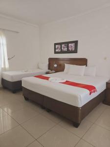 two beds in a hotel room with at The Wild Thing Guesthouse in Serowe