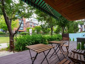 a picnic table and chairs on a wooden deck at Hongik stay2 in Seoul