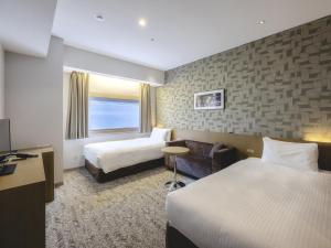 Postel nebo postele na pokoji v ubytování Hotel Gracery Ginza + 37 fotografií