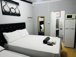 Ένα ή περισσότερα κρεβάτια σε δωμάτιο στο GM Lodge