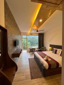 a bedroom with a large bed and a living room at Apurwa Grand Resort in Baragrān