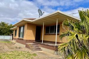 a house with a satellite on top of it at BeeJays Family Getaway in Kingscote