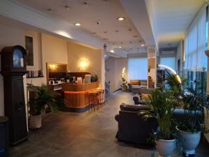 a lobby with couches and a bar in a building at Hotel La Capannina in Genova +24 photos
