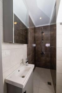 a bathroom with a sink and a shower at Seda Holiday in Alanya