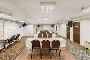 a conference room with a table and chairs in it at Days Inn by Wyndham Raleigh-Airport-Research Triangle Park in Morrisville
