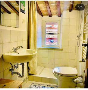 a bathroom with a sink and a toilet at Il Vicolo apartment in the village in Manziana +14 photos