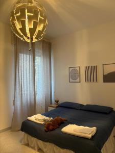 a bedroom with a bed and a chandelier at Casa dell'Opera in Pesaro