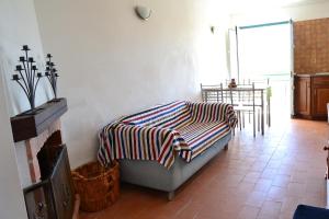 a bedroom with a bed with a striped blanket on it at Lagos Rustic House in Barão de São João