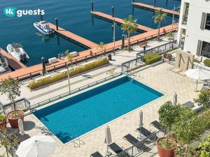 an overhead view of a swimming pool next to the water at HiGuest - Stylish 1BR Apartment in La Mer in Dubai +27 photos