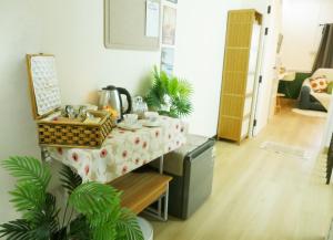 a kitchen with a table with a table cloth at Enjoyo Getaway in Bangkok