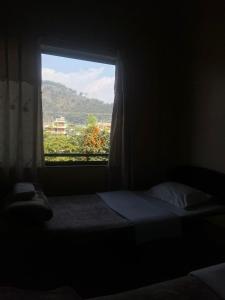 Voodi või voodid majutusasutuse Cherry Garden Pokhara toas