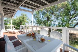 a white table and chairs on a porch at Club del Sole Stork Family Collection in Giulianova