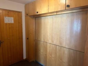 a large closet with wooden walls and a door at Diablerets D 010 -MOUNTAIN apartment 6 pers in Veysonnaz