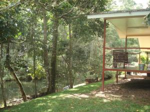 a pavilion with a view of a body of water at Chilverton Cottages in Ravenshoe