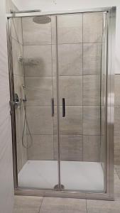 a shower with a glass door in a bathroom at B&B Monté in Montesilvano