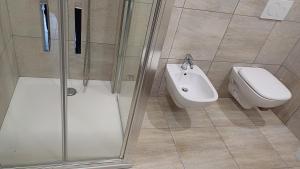 a bathroom with a shower and a toilet and a sink at B&B Monté in Montesilvano