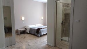 a bedroom with a bed and a walk in shower at B&B Monté in Montesilvano