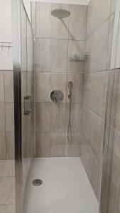 a shower with a glass door in a bathroom at B&B Monté in Montesilvano