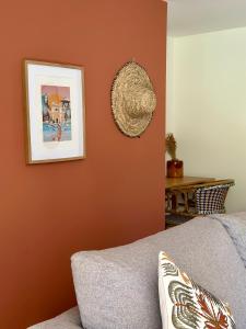 a living room with orange walls and a couch at Hôtel Palombaggia in Porto-Vecchio