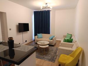 a living room with a couch and a table at Unity 1 in Tatu City