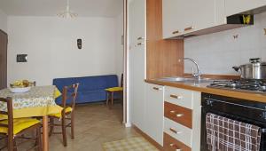 a kitchen with a table and a stove top oven at Terrazza Paola in Alghero