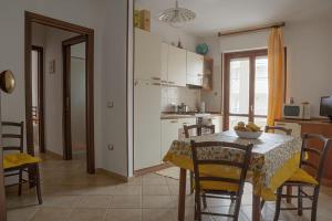 a kitchen and dining room with a table and chairs at Terrazza Paola in Alghero