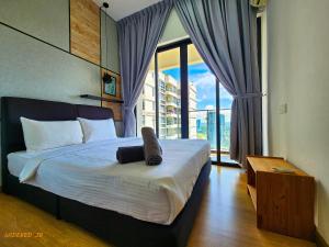 a bedroom with a large bed with a large window at Country Garden Danga Bay By Widebed JB in Johor Bahru +112 photos