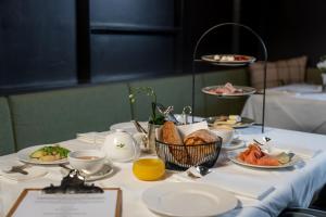 a table with plates of food on it at Hotel Burgwald in Lech am Arlberg