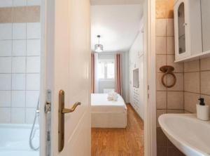 a bathroom with a sink and a bed in a room at Rea Apartment in Argostoli +33 photos