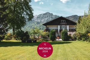 a house with a sign in front of a yard at Villa Sonnenhof Boutique-Hotel in Bad Reichenhall