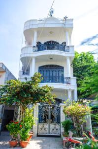 a white building with a balcony on top of it at La Jonquille Vũng Tàu in Vung Tau